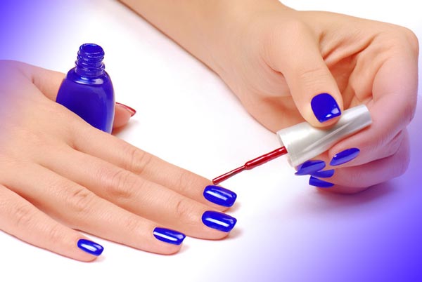 Applying the main nail polish after doing the nail manicure steps