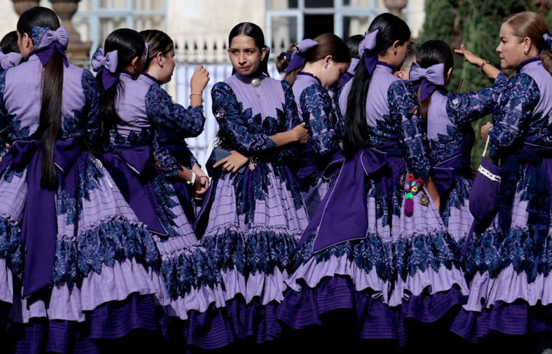 Traditional cowgirls before eering a church during a celebration in Mexico