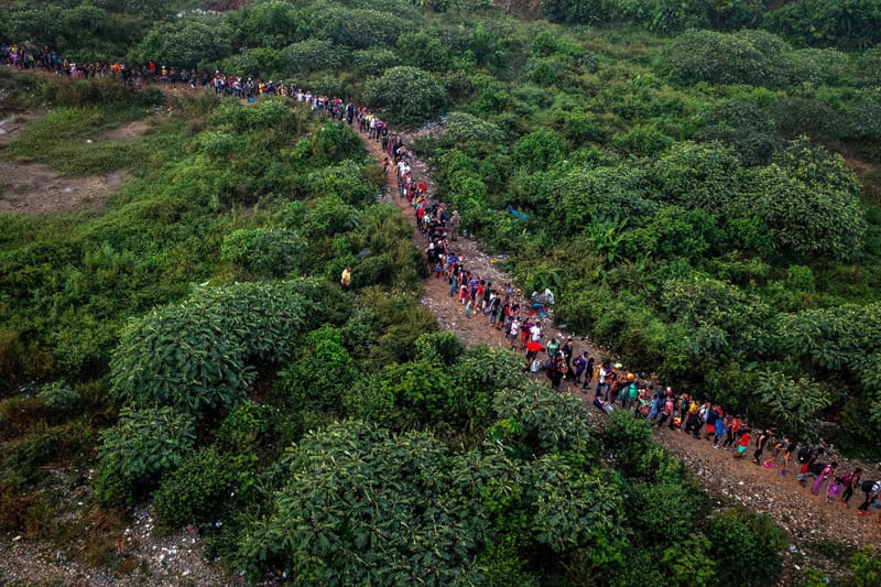 Immigras move on the Darien Gap road on the way to <a href=
