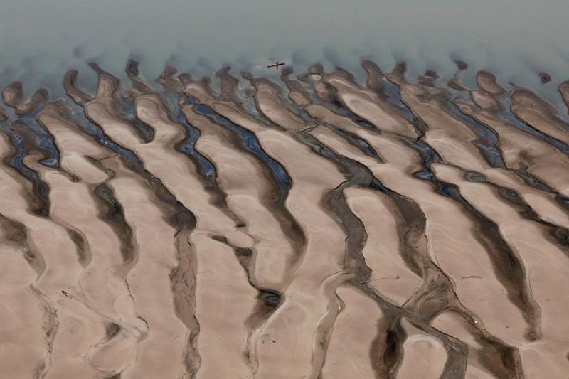 The sandy shores of the Tefé River, one of the largest tributaries of the Amazon in Brazil, following the widespread drought in Brazil