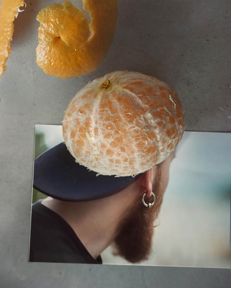 Combined photo of tangerine and man's hat 