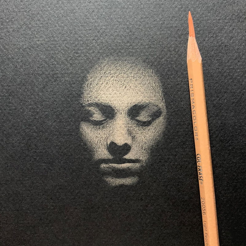 White pencil drawing of a woman's face with closed eyes