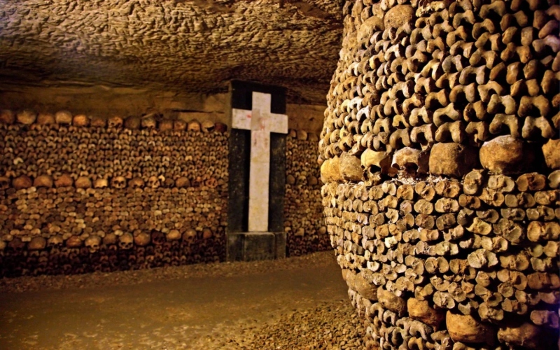 Paris catacombs with a wall of bones; Photo source: afar.com site. Photographer: Heracles Kritikos