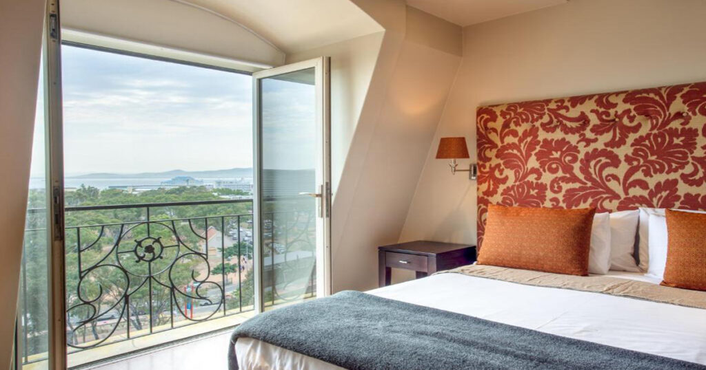 An image of Cape Royal Hotel's bedroom with a private balcony
