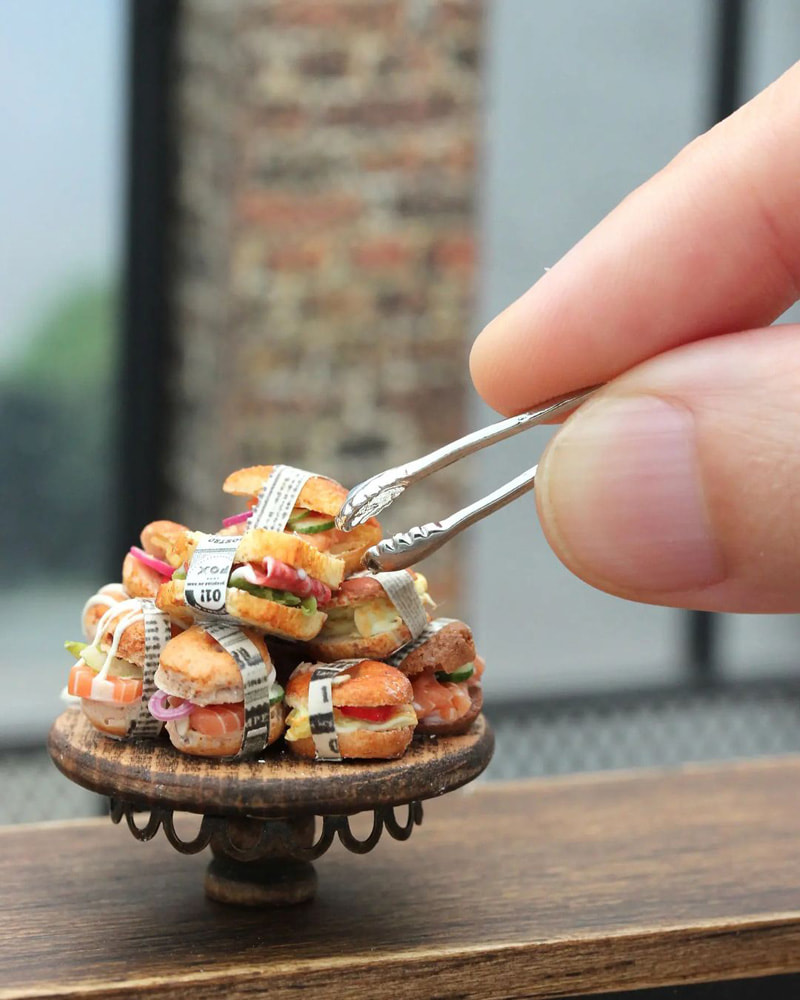 A coainer of miniature sandwiches made by Shai Aaron