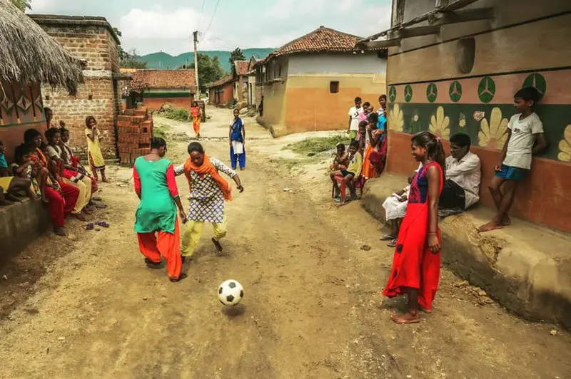 Indian women playing football in the street