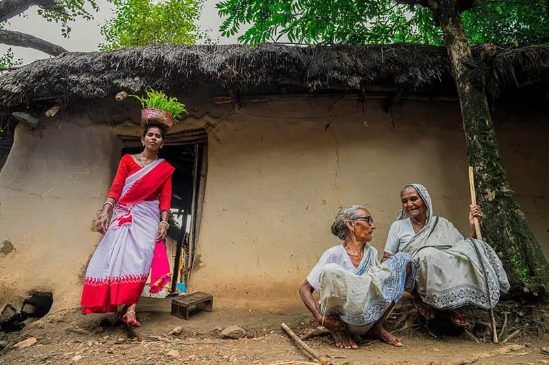 Indian woman with a basket on her head in the alley