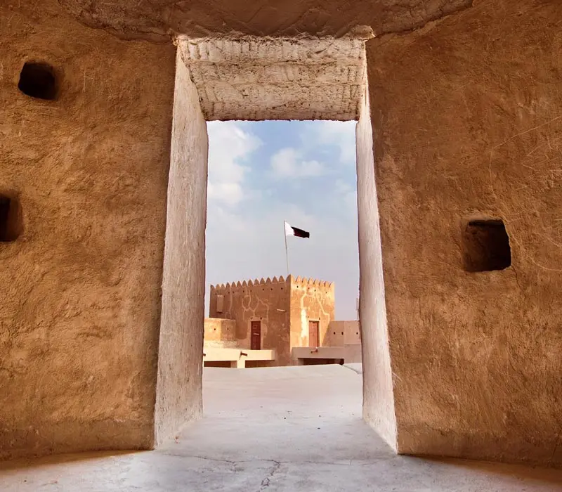 The flag of Qatar over the observation tower of Al Zabareh Fort; Photo source: bucharest.embassy.qa, photographer: unknown