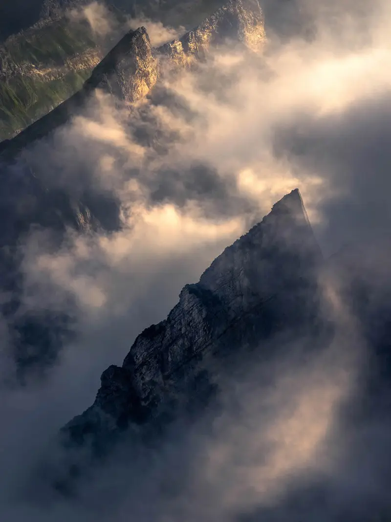Clouds and sun at the top of the Alps