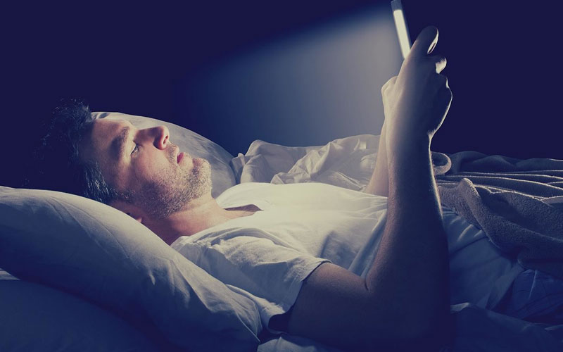 Playing with a mobile phone while sleeping at night