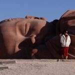 Photo with the Son of Earth statue, in the form of a sleeping baby in the Gobi desert in Gansu Province, China; Photo source: the guardian; Photographer name: Tingshu Wang