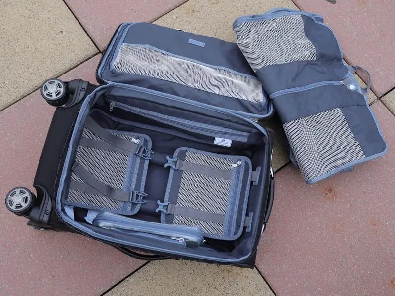 A suitcase with multiple iernal compartmes and a formal dress cover; Photo source Businessinsider.com. Unknown photographer