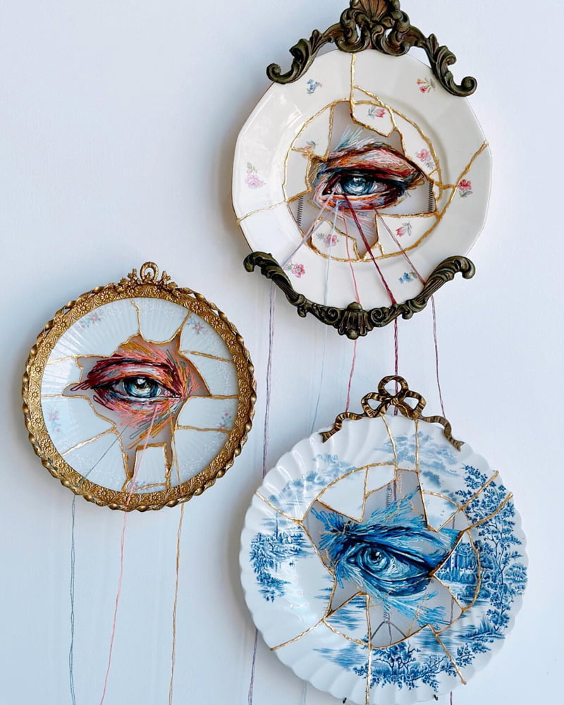 Three embroidered porcelain plates