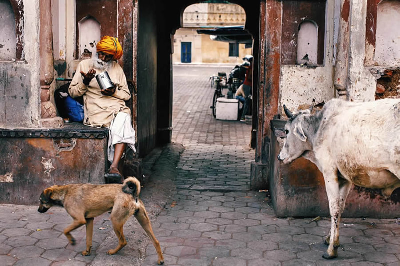 Indian religious man next to the building