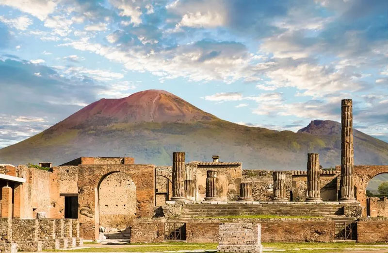 the ancie walls of Pompeii and Mou Vesuvius in the background; Photo Source: Forbes, Photographer: Unknown