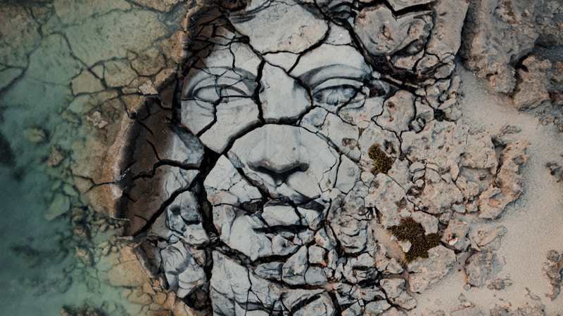 Painting of human face on stone ground