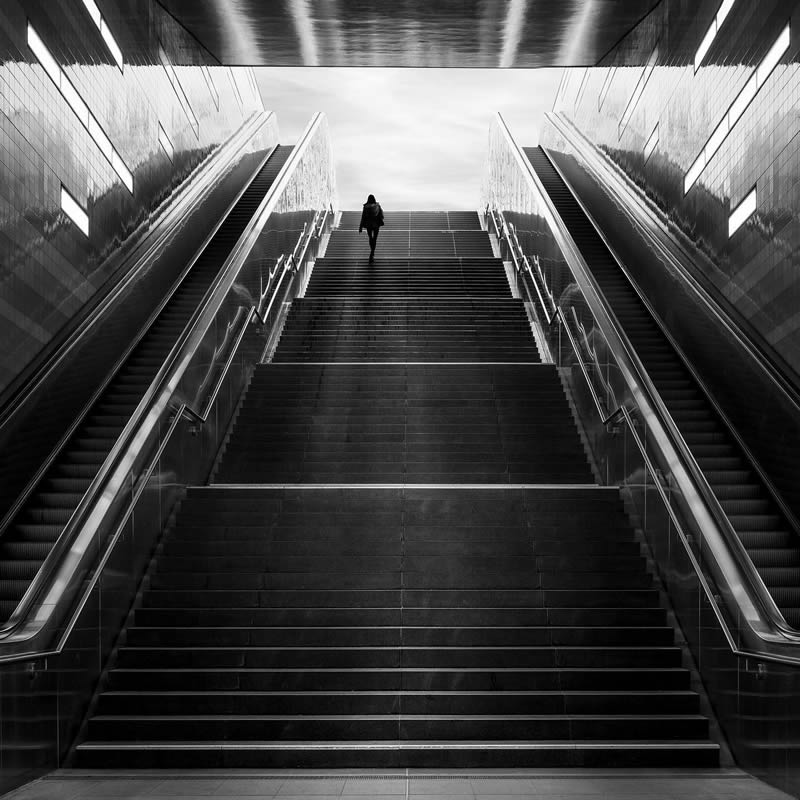 A person on a tall city staircase