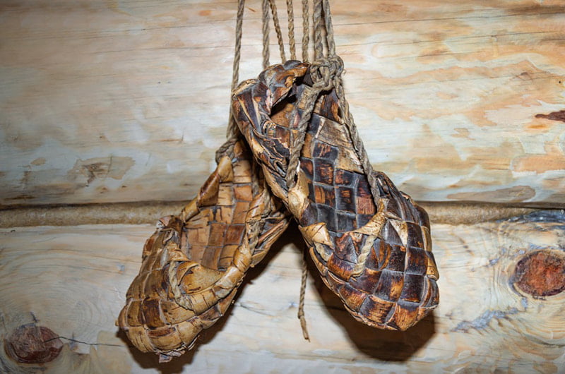 old shoes hanging on the wall; Photo source: discovermagazine; Name of the photographer: unknown