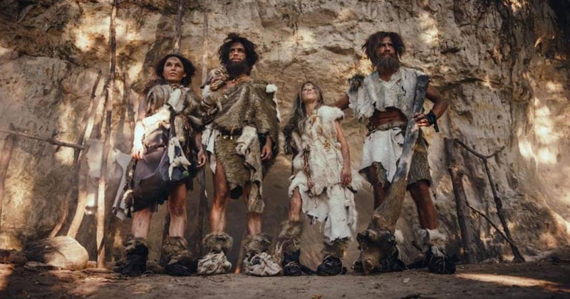 four people in primitive human clothes; Photo source: Ancie Origins; Name of the photographer: unknown 