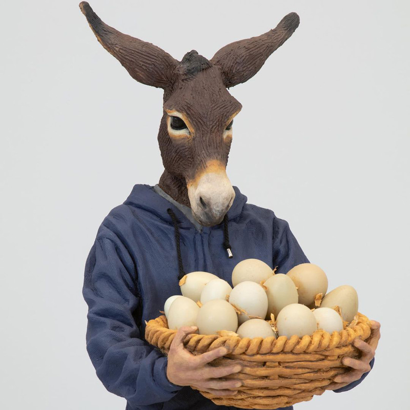 Statue of a donkey with a basket of eggs