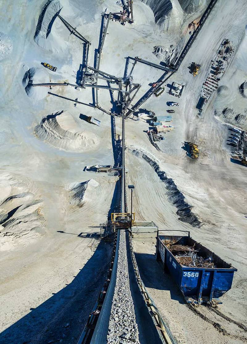 A panoramic photo of a rail in a snowy area