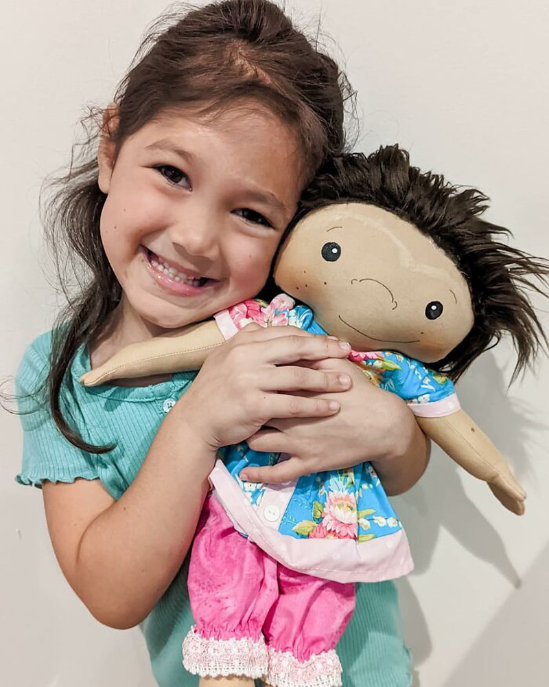 Smiling little girl and her doll