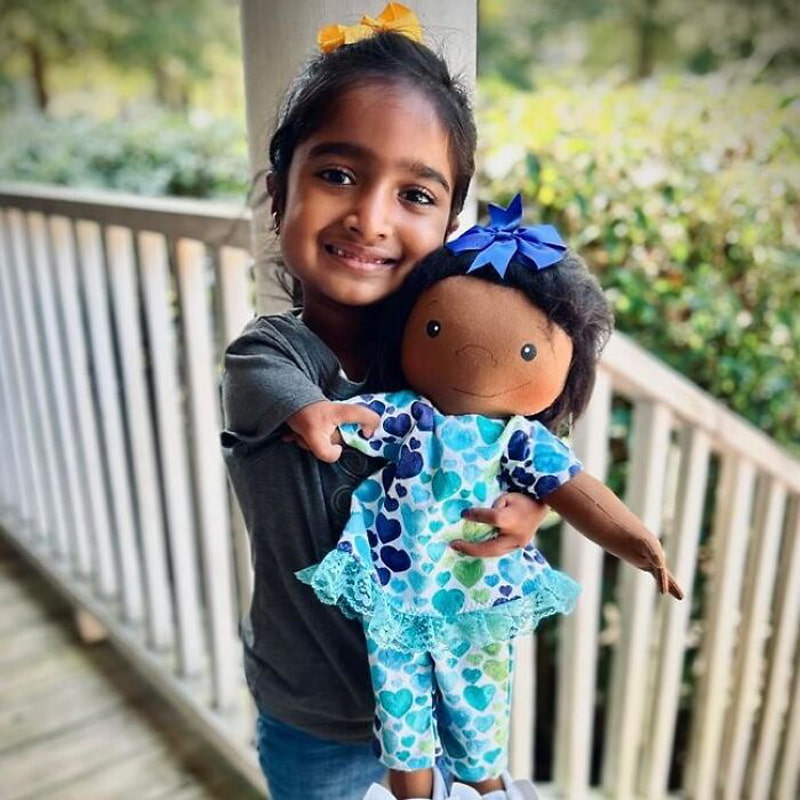 Asian girl with a doll like herself
