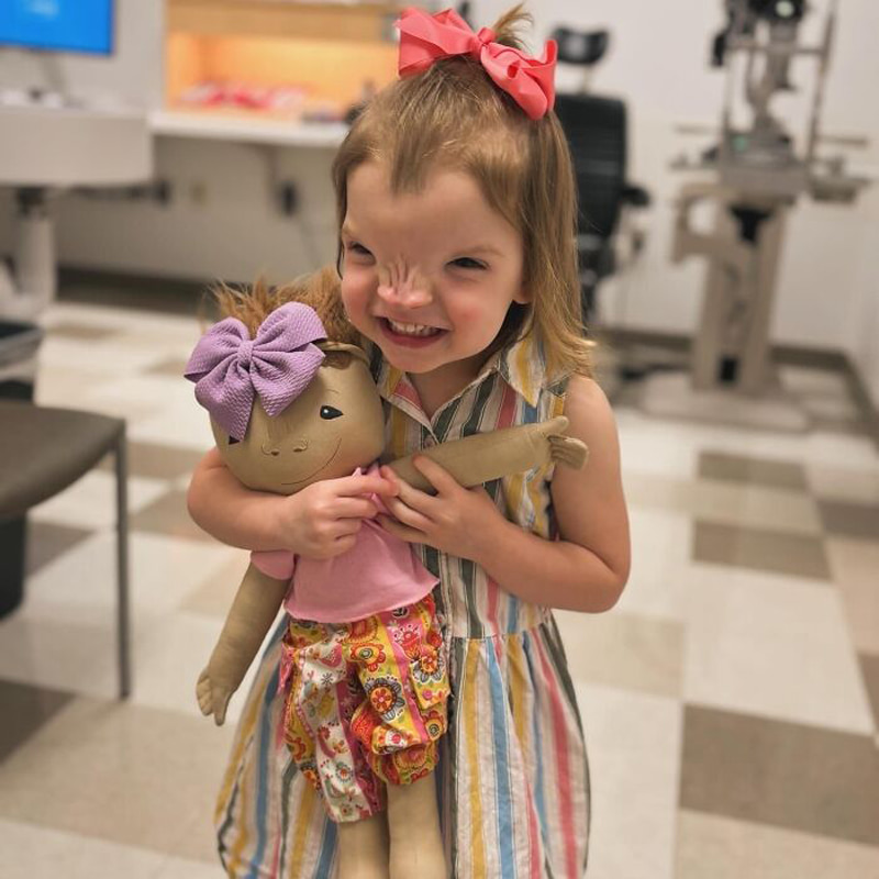 Golden haired girl with a doll like herself