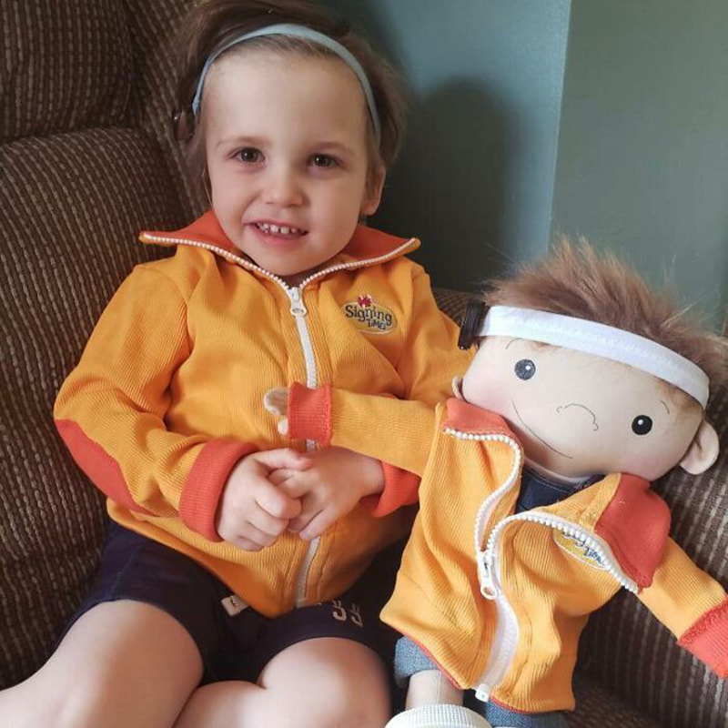 A girl and a doll with a jacket