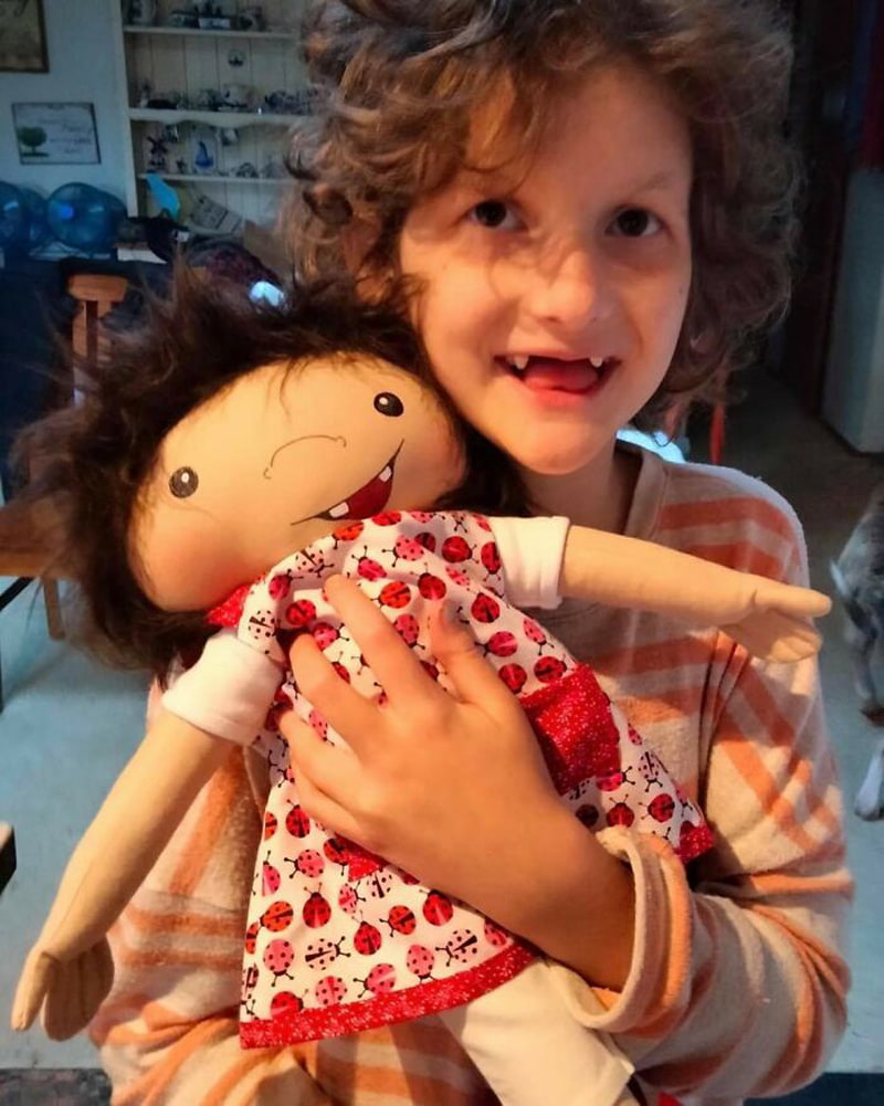 Happy girl and red doll