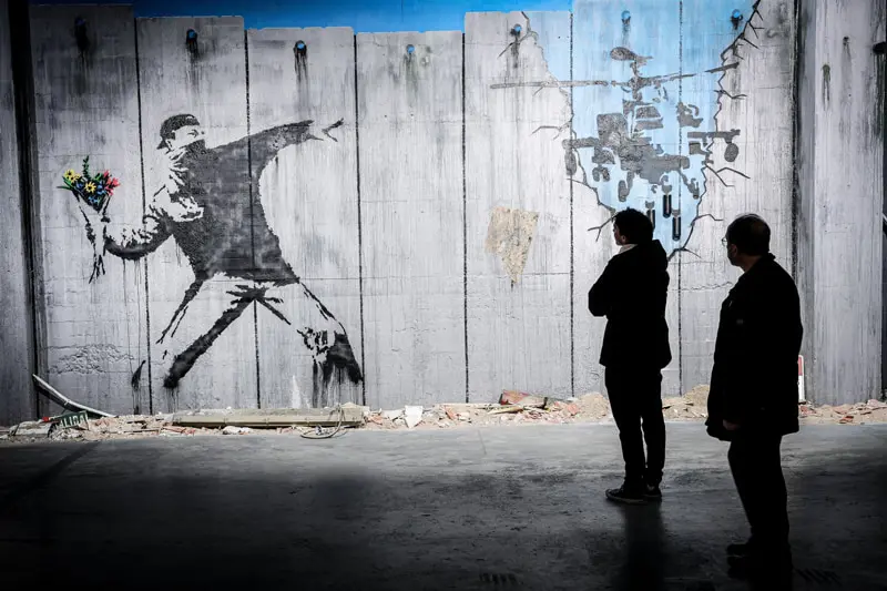 Conceptual paiing of throwing flowers instead of stone; Banksy's effect
