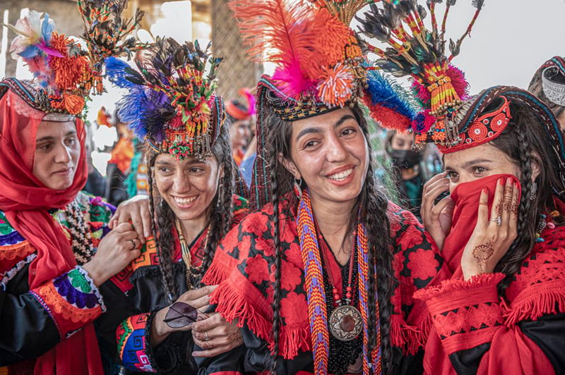 Girls laughing with red clothes; Photographer: Jo Kearney from Britain