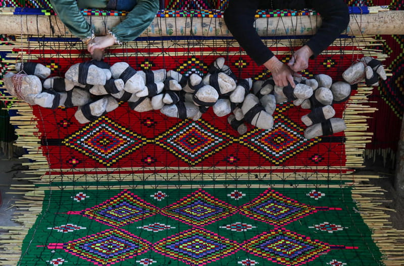 Women's handmade carpets in a traditional Kurdish carpet shop in Iraq; Photo Source: Theguardian; Photographer's name: Unknown 