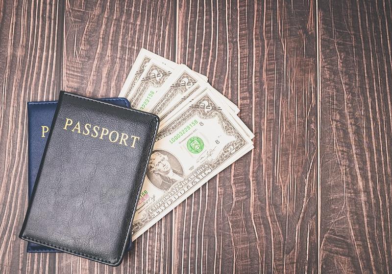 Dollars and passports for foreign trips; Photo Source: vecteezy.com; Photographer: aukideezy