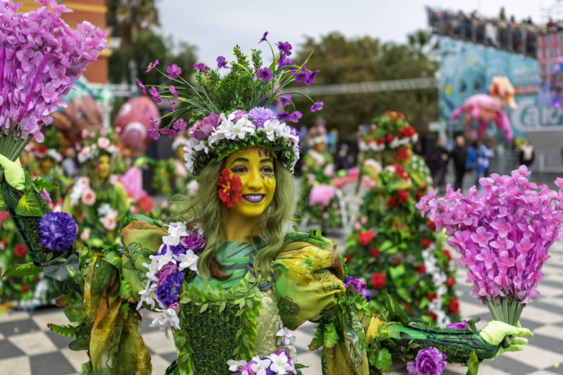 A woman at the Flower Battle eve in Carnival City Nice, France; Photo Source: Theguardian; Photographer's name: Unknown
