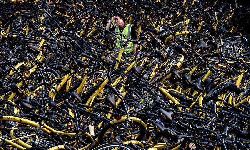 The Chinese man among the mass of damaged bicycles; Photographer: Kevin Frayer