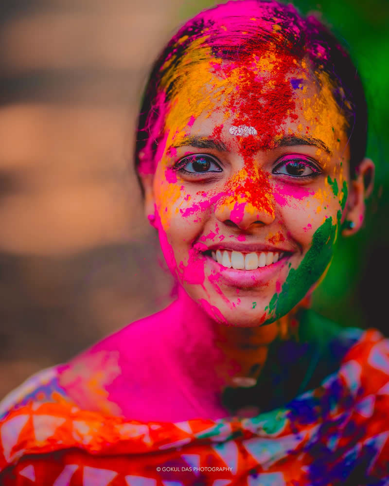 Hindi woman with a paied face at the Holi celebration 