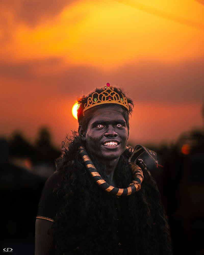   An Indian man with a golden crown and necklace