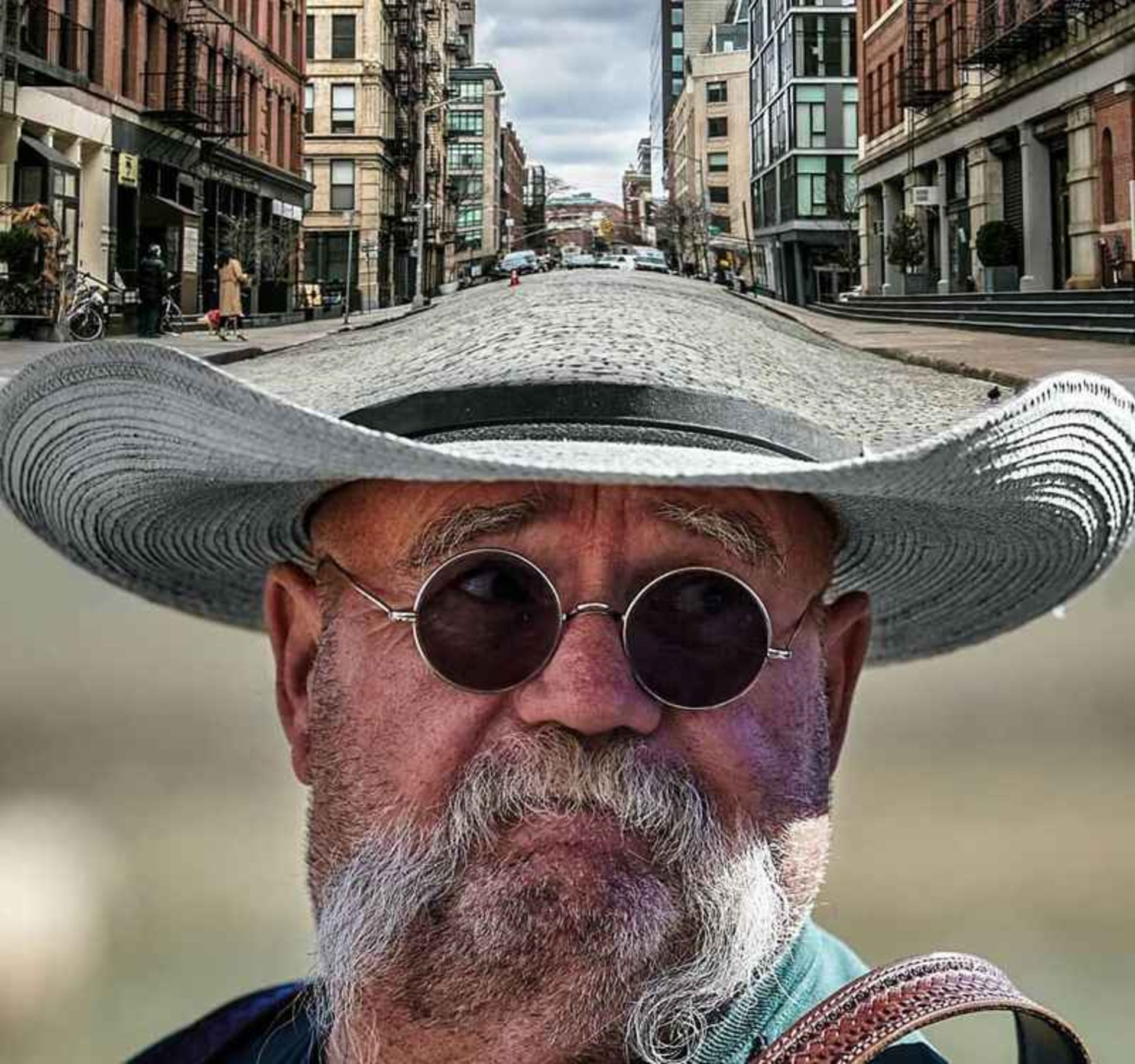 Surreal photo of the road above a hat of an old man