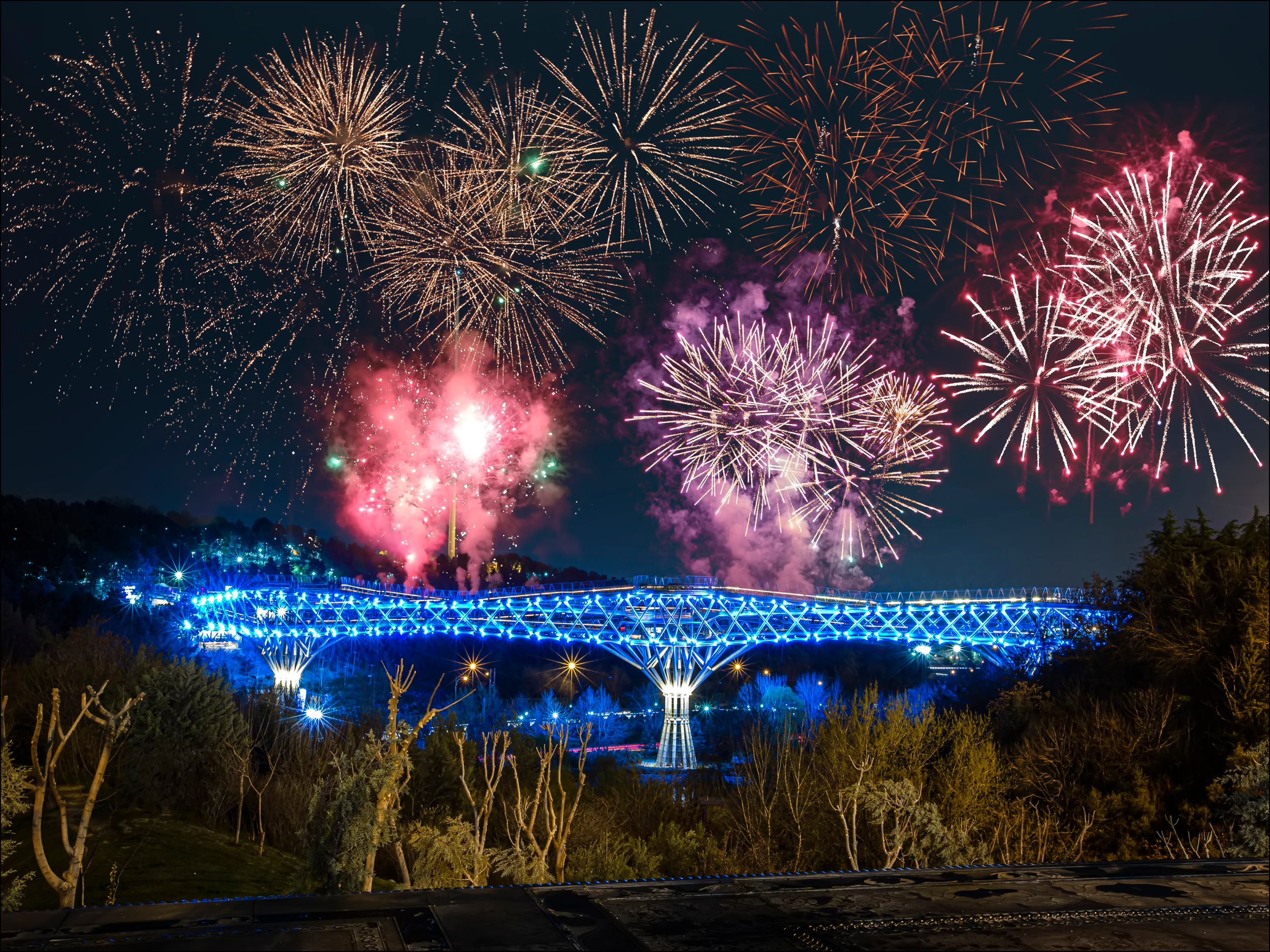 A metal bridge with fireworks