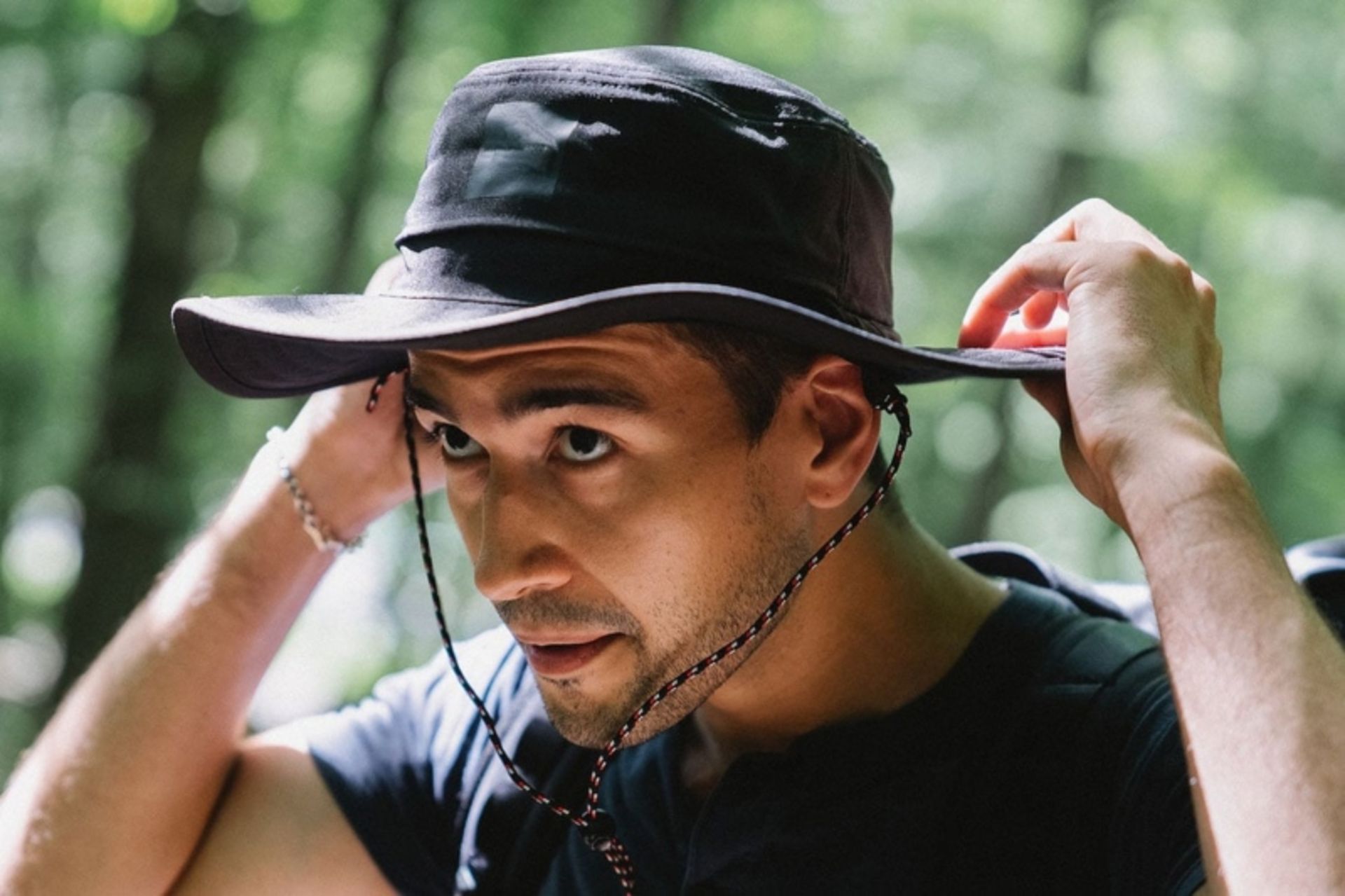 A man with a sunny hat in nature
