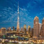 Dubai's Caliph Tower in the midst of the skyscrapers at night