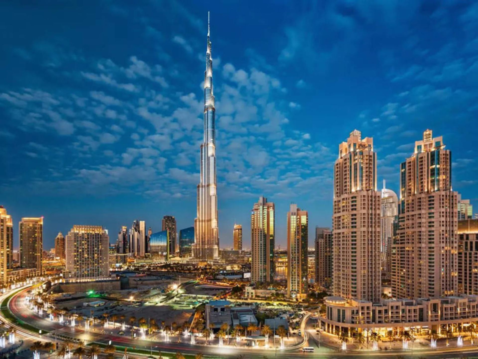 Dubai's Caliph Tower in the midst of the skyscrapers at night
