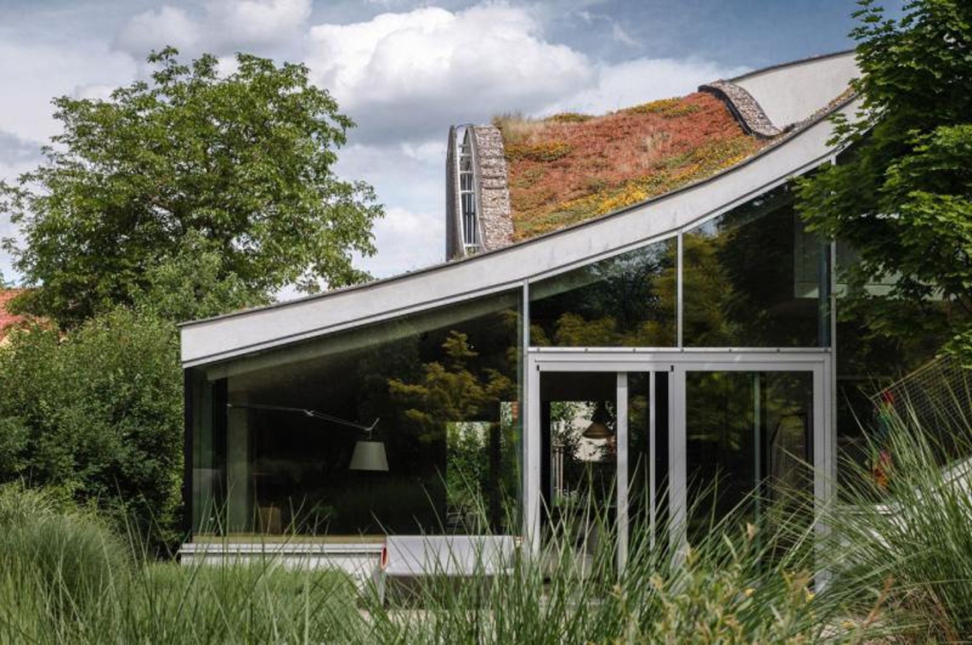 Home with a green roof in the woods