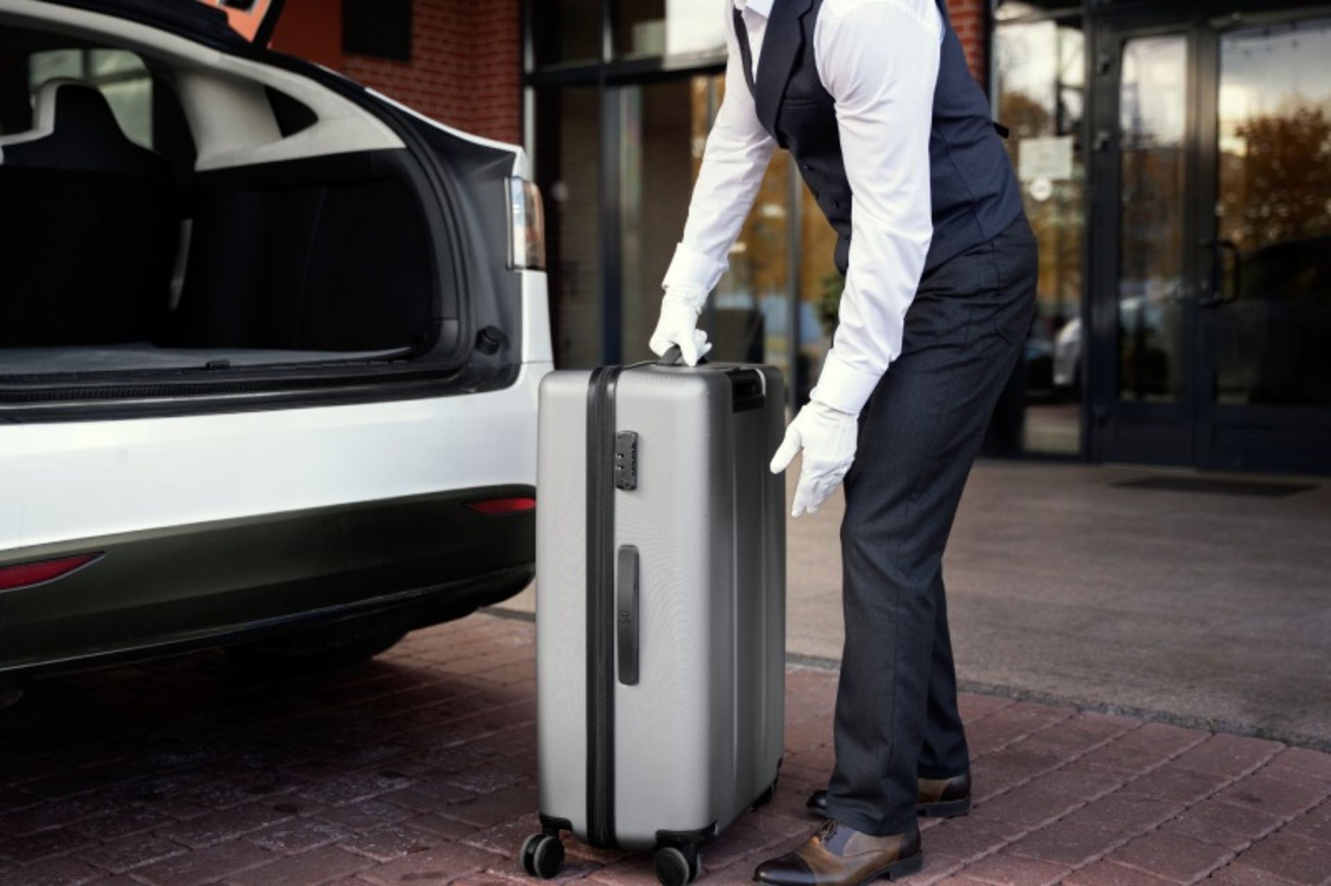 Hotel crew is picking up the suitcase