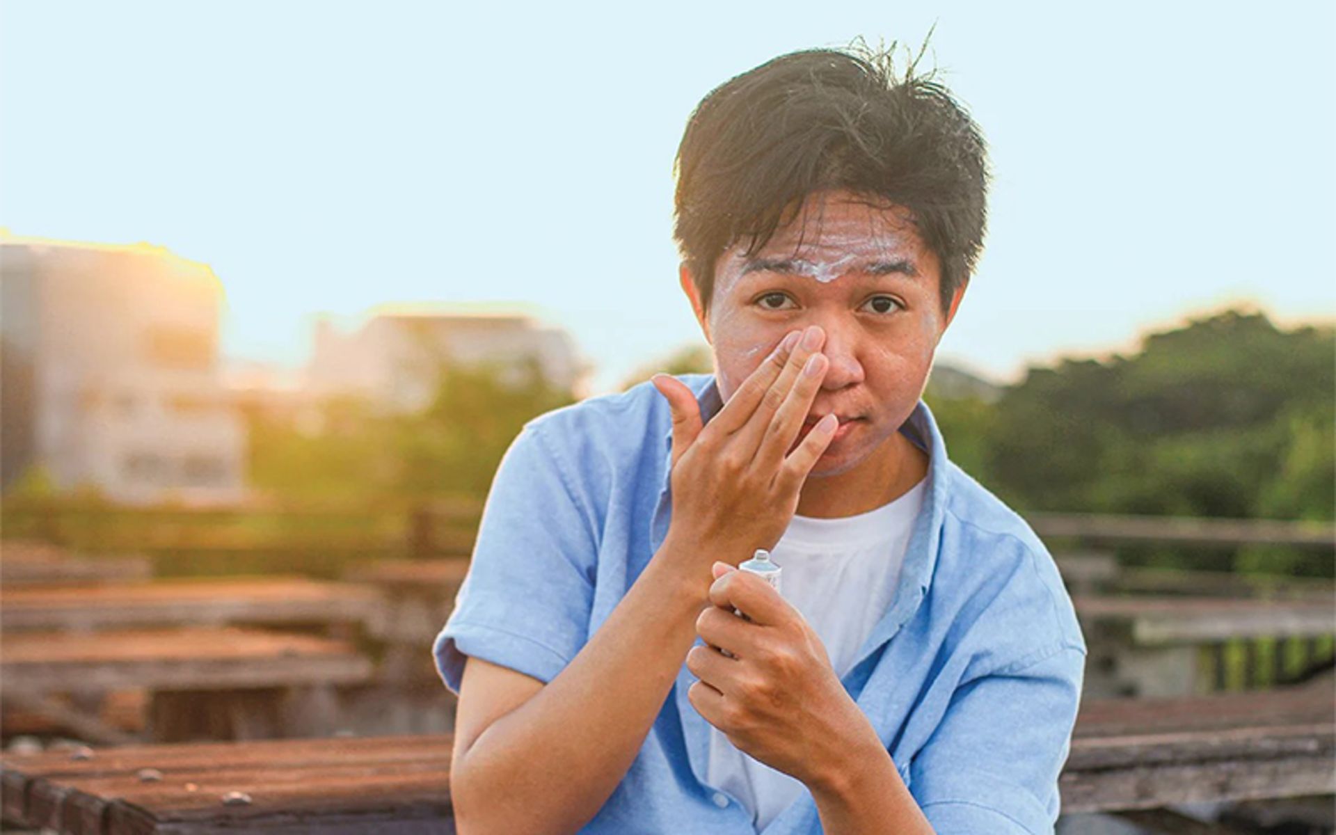Sunscreen on the face of the tourist man