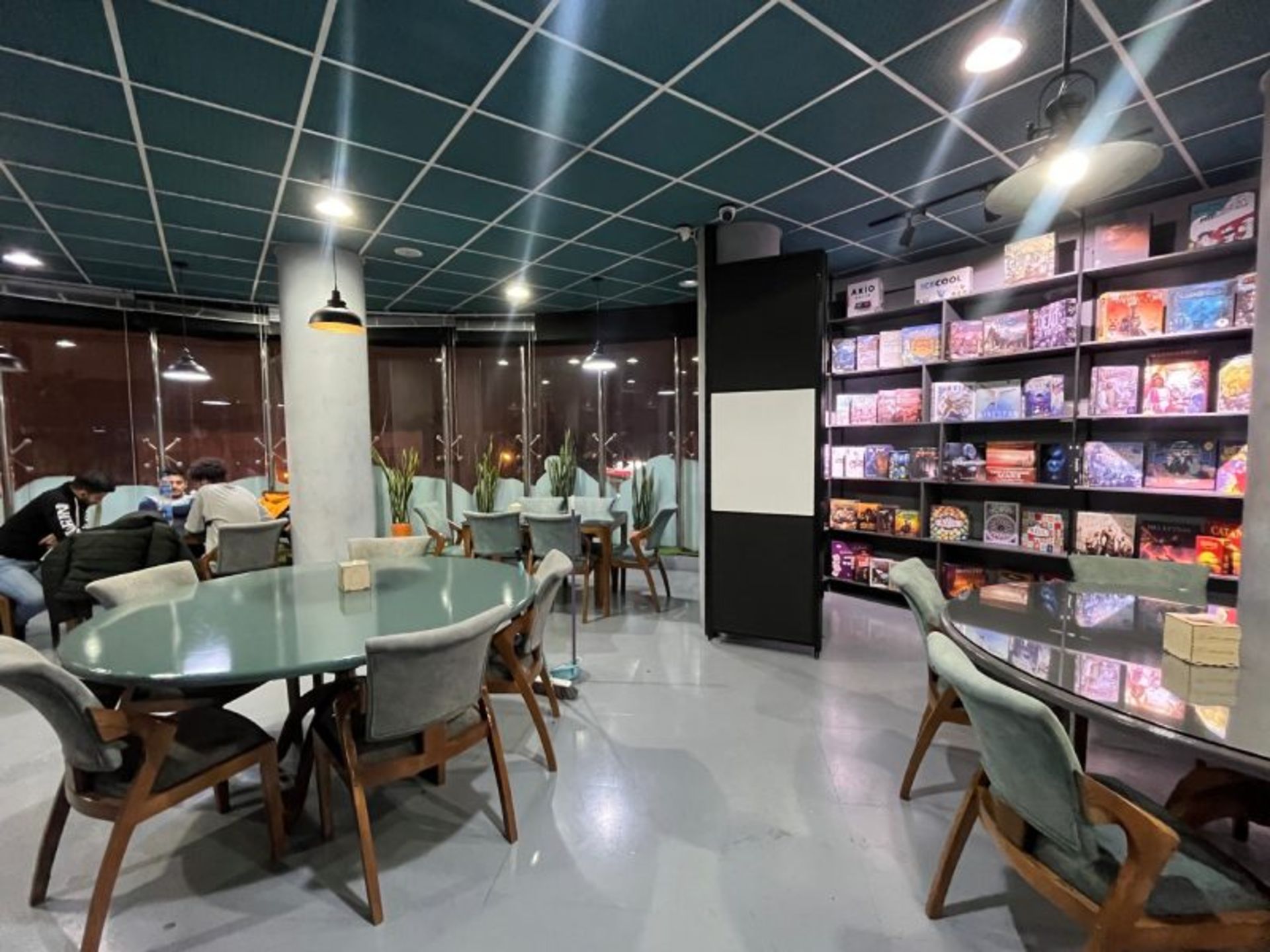 Qom Cafe Cafe Hall with differe games shelves