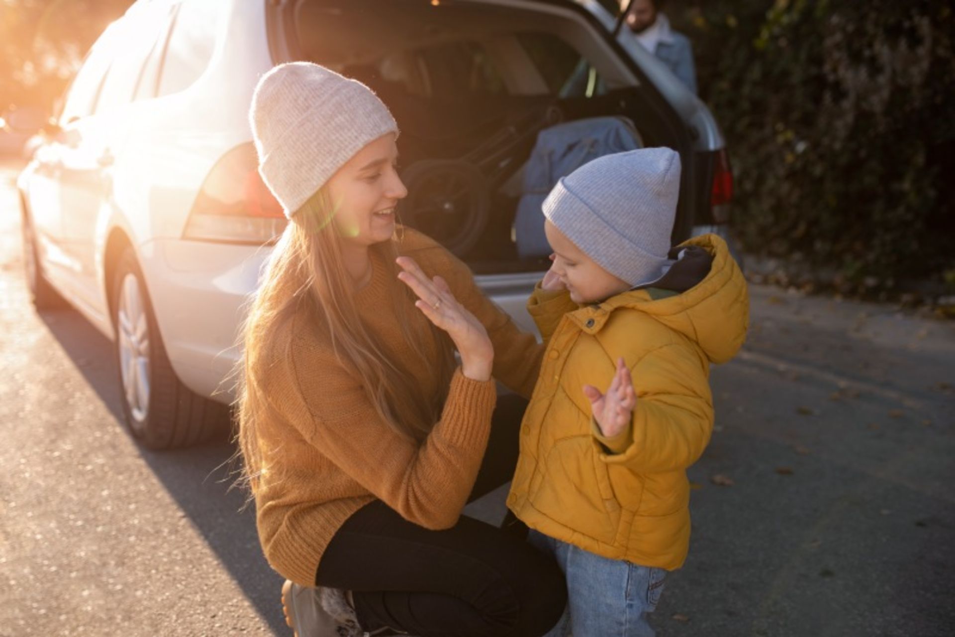 Mother and baby next to the car
