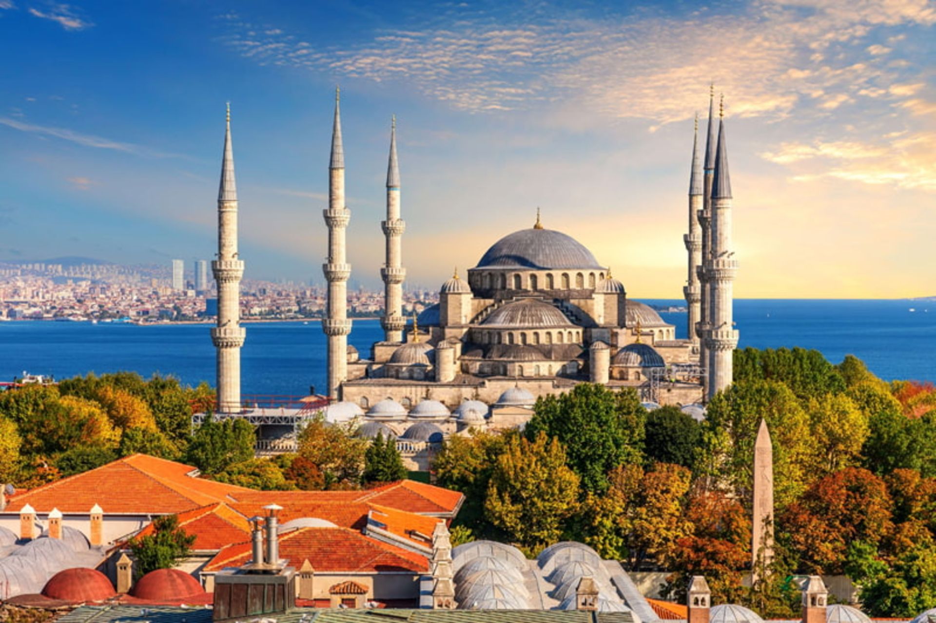 The dome and minaret of the Blue Mosque in the autumn nature of Istanbul