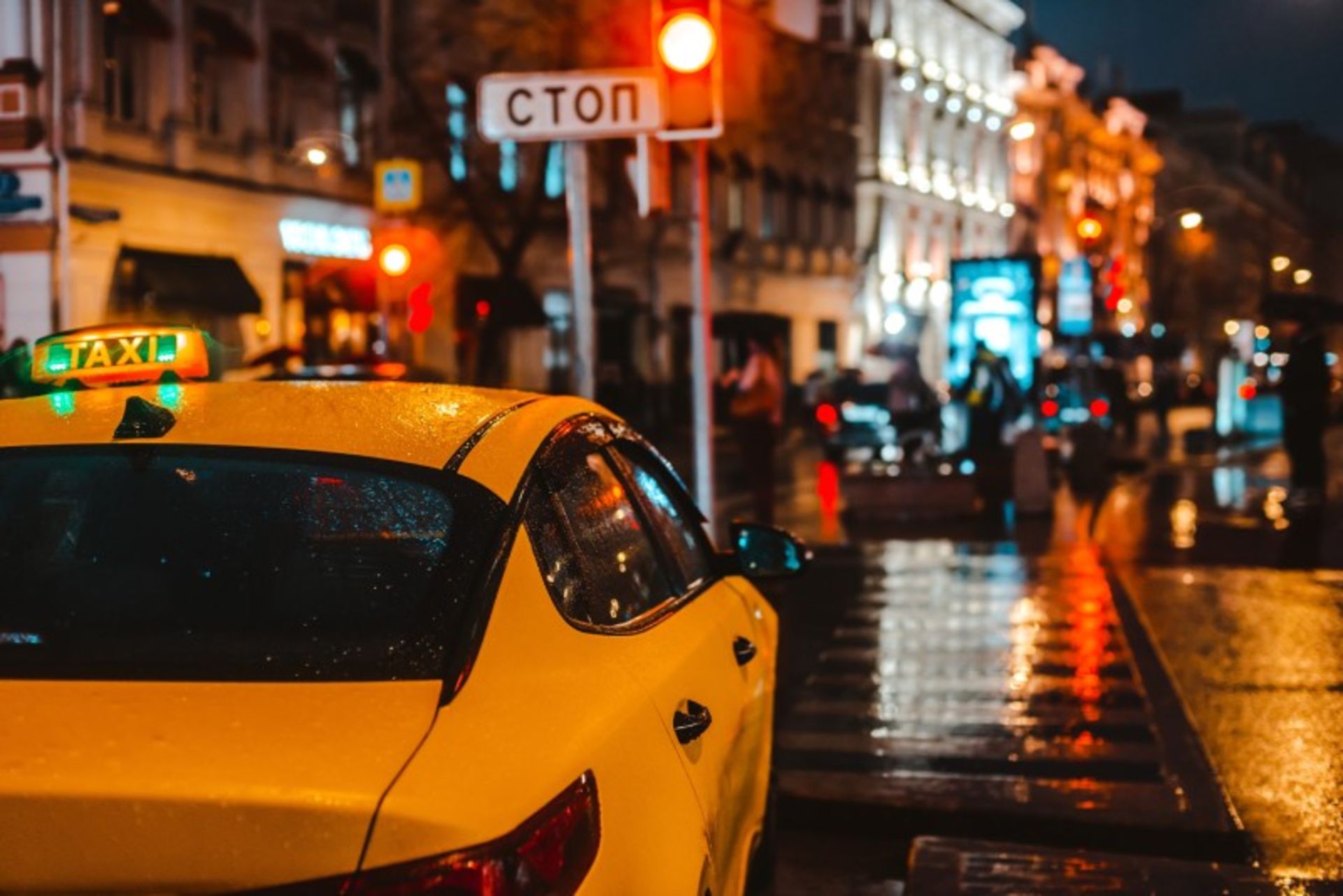 Yellow taxi on the street in the night